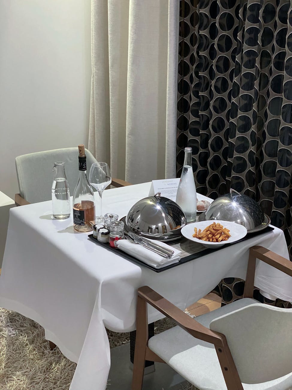 a table with two plates and two glasses on it